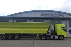 Lime green truck in front of building