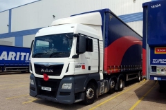 Bibby MAN cab with curtainsider trailer bearing remembrance Poppy