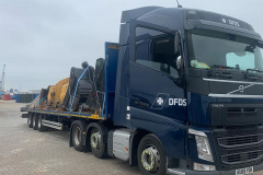 DFDS Volvo Truck with a flatbed trailer loaded with digger buckets