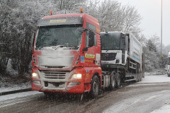 Hutchinson Transport with low loader carrying refuse truck
