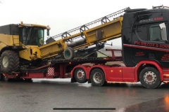 P W Wilcox and Sons Scania R500 loaded with a Combine Harvester