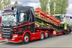 P W Wilcox and sons Scania R500 with low loader carrying combine harvester