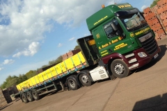 R Swain and Sons DAF CF with flatbed trailer loaded with bricks