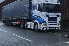 White Scania truck with great graphics and curtainsider trailer