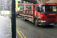 Scania Rigid truck flatbed with steel being unloaded with a crane